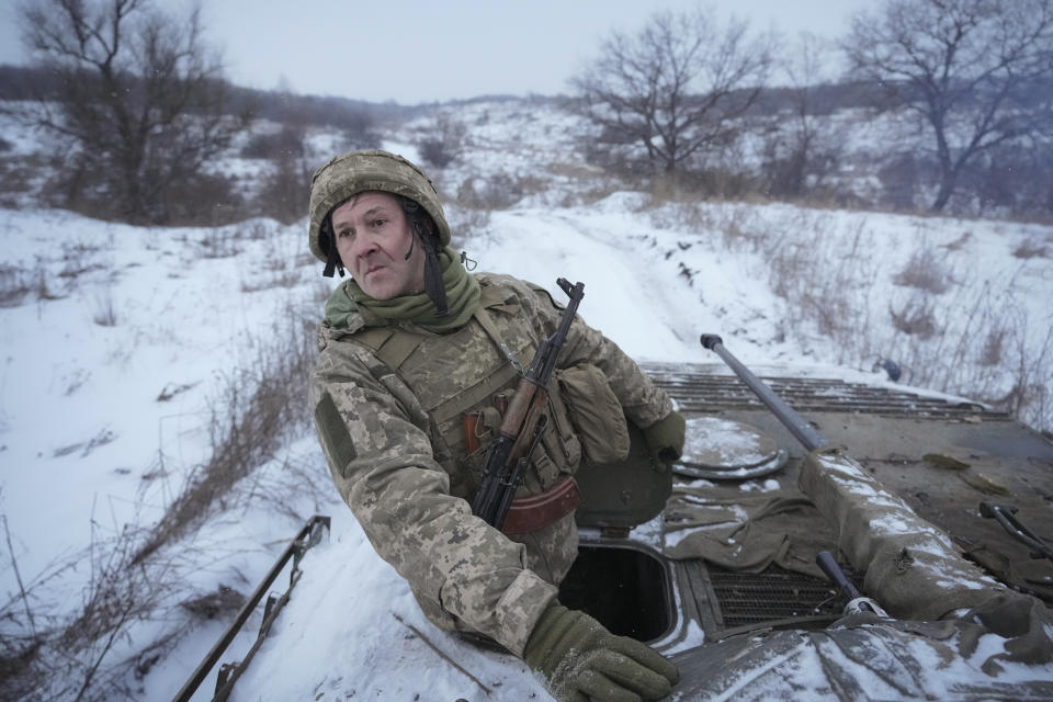 FILE A Ukrainian serviceman looks back from atop an armored personnel carrier driving near a front line position in the Luhansk area, eastern Ukraine, Friday, Jan. 28, 2022. As a political novice running to be Ukraine’s president, Volodymyr Zelenskyy vowed to reach out to Russia-backed rebels in the east who were fighting Ukrainian forces and make strides toward resolving the conflict. The assurances contributed to his landslide victory in 2019. (AP Photo/Vadim Ghirda, File)