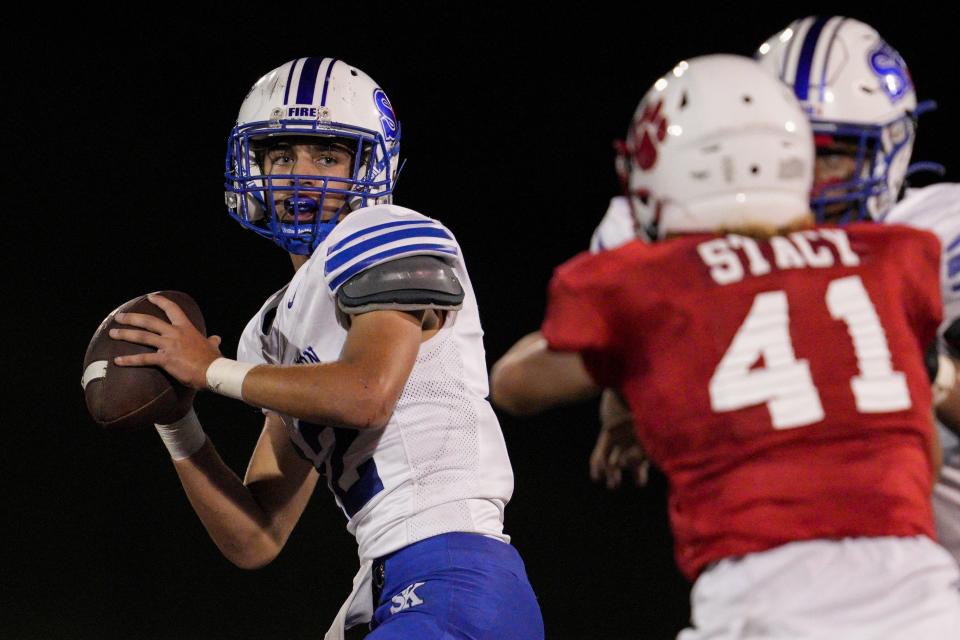 Simon Kenton's Tucker Ober, left, prepares to throw during a KHSAA high school football game against the Beechwood Tigers at Beechwood High School Friday, Sept. 9, 2022, in Fort Mitchell, Ky.