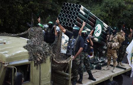 Palestinian Hamas militants take part in a military parade marking the first anniversary of the eight-day conflict with Israel, in Gaza City November 14, 2013. REUTERS/Suhaib Salem