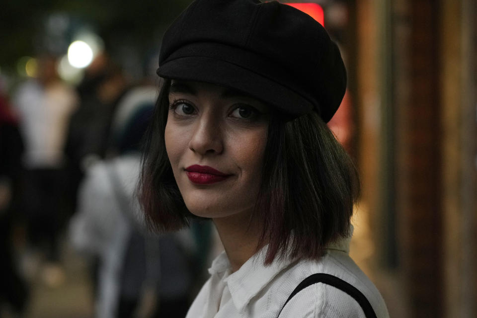 FILE - An Iranian woman without wearing her mandatory Islamic headscarf walks in downtown Tehran, Iran, June 10, 2024. (AP Photo/Vahid Salemi, File)