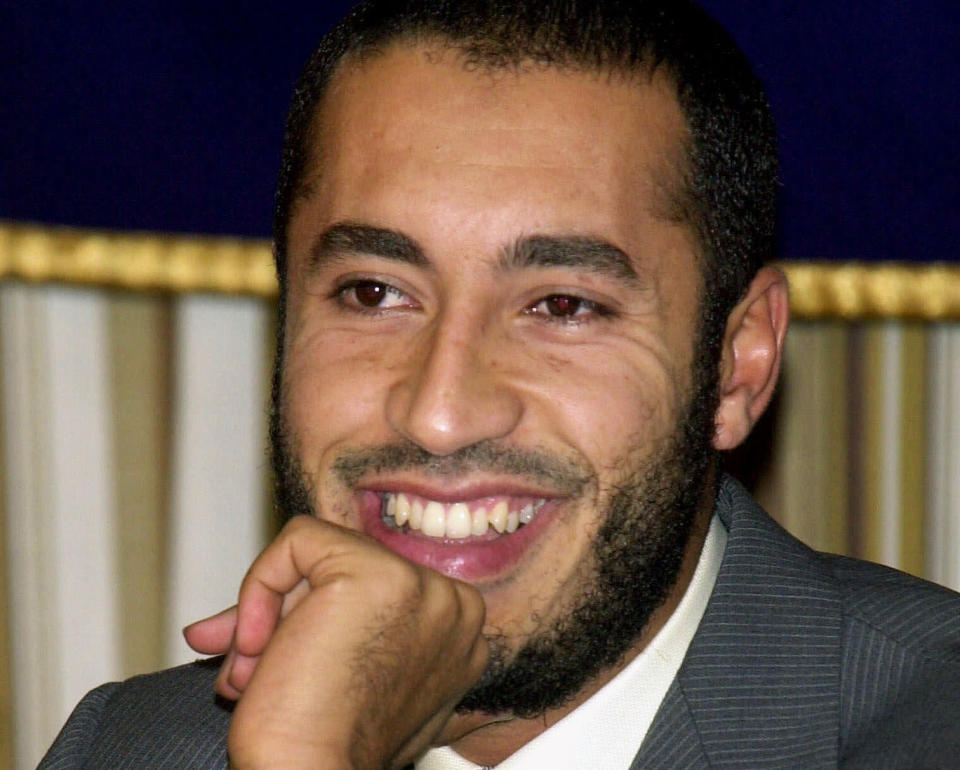 FILE - In this Tuesday, July 3, 2001 file photo, Al-Saadi Gadhafi, son of Libyan leader Moammar Gadhafi, smiles during a press conference at the Foreign Correspondents' Club of Japan in Tokyo. Libya says Niger has extradited Moammar Gadhafi's son al-Saadi, who fled as his father's regime crumbled in 2011 and who was under house arrest in the desert West African nation ever since. A Libyan official, who spoke on condition of anonymity in line with regulations, says al-Saadi arrived early on Thursday March 6, 2014 at the Tripoli airport and was transferred to a prison in the capital. (AP Photo/Tsugufumi Matsumoto, File)