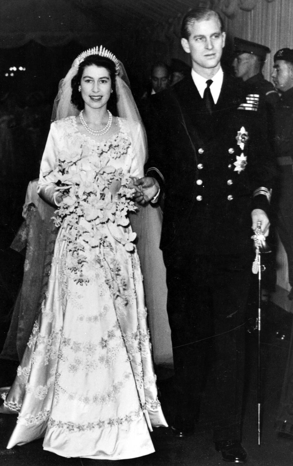 Queen Elizabeth II, as Princess Elizabeth, and her husband the Duke of Edinburgh, styled Prince Philip in 1957, on their wedding day. She became queen on her father King George VI's death in 1952
