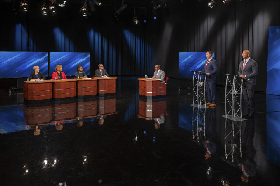 This image released by Maryland Public Television shows gubernatorial candidates Democrat Wes Moore, right, and Republican Dan Cox, second from right, as they stand on a stage during a debate ahead of the election, Wednesday, Oct. 12, 2022, in Owings Mills, Md. Also on state are panelists, from left, Pamela Wood, of The Baltimore Banner, Tracee Wilkins, of WRC-TV/NBC4 in Washington, Alexis Taylor, of AFRO-American, and Jeff Salkin, of Maryland Public Television, along with moderator Jason Newton, of WBAL-TV. Republican Gov. Larry Hogan is term limited. (Maryland Public Television/Michael Ciesielski via AP, Pool)
