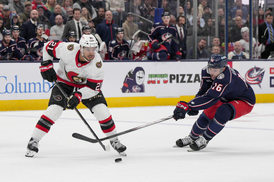 Ottawa Senators right wing Mathieu Joseph (21) controls the puck against Columbus Blue Jackets center Brendan Gaunce (16) during the second period of an NHL hockey game Thursday, March 14, 2024, in Columbus, Ohio. (AP Photo/Jeff Dean)