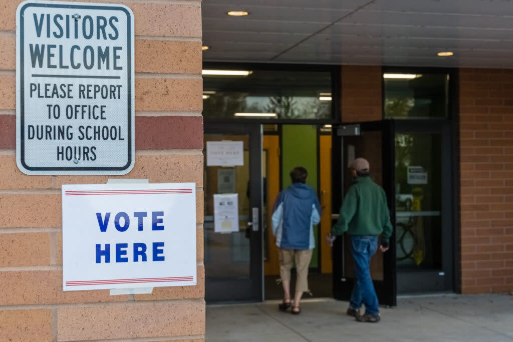 Voters enter an elementary school