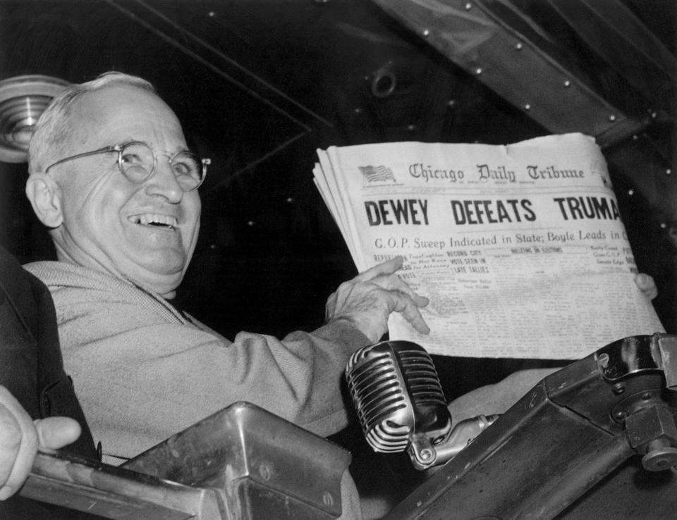 In this Nov. 4, 1948, file photo, President Harry S. Truman holds up an election day edition of the Chicago Daily Tribune, which, based on early results, mistakenly announced “Dewey Defeats Truman.”