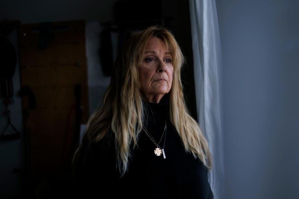 Jocelyn Cronin stands in her window in Petaluma, California. 