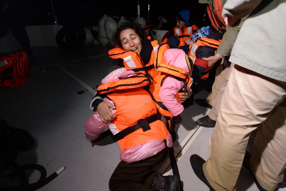 Syrians woman holds her children after 50 refugees captured by Turkish coast guard while they were illegally trying to reach Greece's Kastellorizo island, in shores of Kas District of Antalya, southern province of Turkey on February 24, 2016.&nbsp;