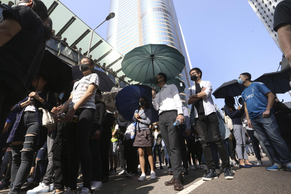 Demonstrators gather during a protest in the financial district in Hong Kong, Friday, Nov. 15, 2019. Protesters who have barricaded themselves in a Hong Kong university partially cleared a road they were blocking and demanded that the government commit to holding local elections on Nov. 24. (AP Photo/Achmad Ibrahim)