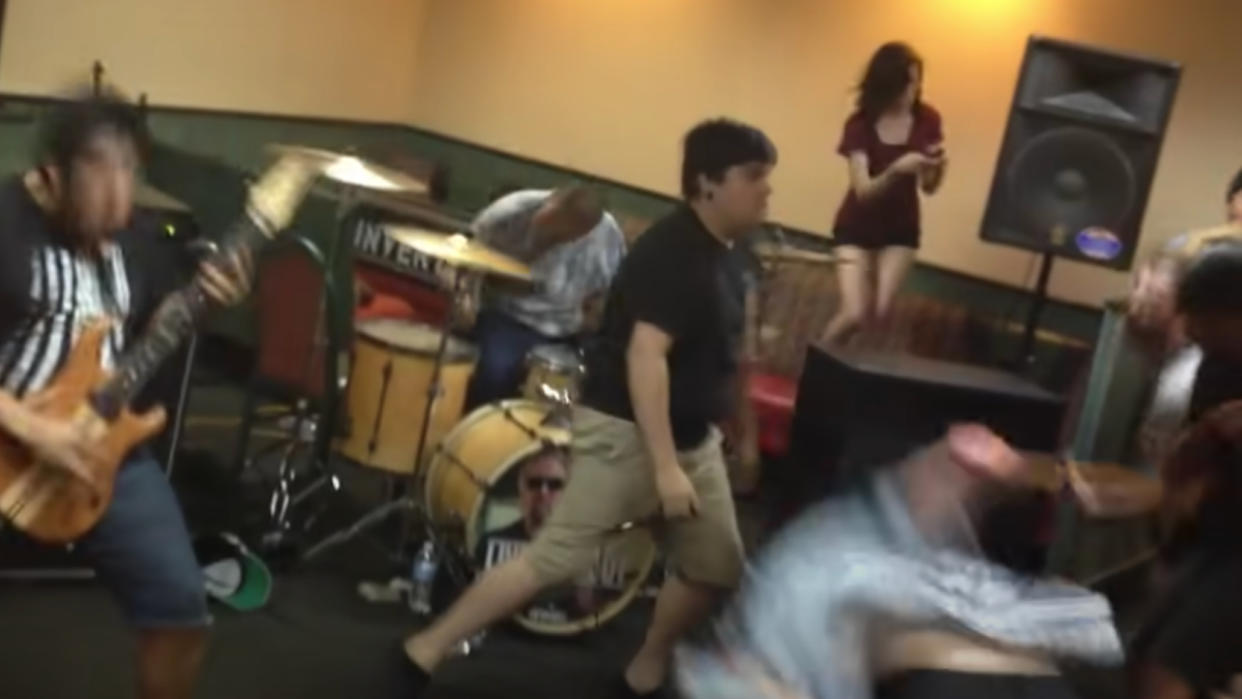  A metal band performing in a Denny's restaurant, in front of a raging moshpit 