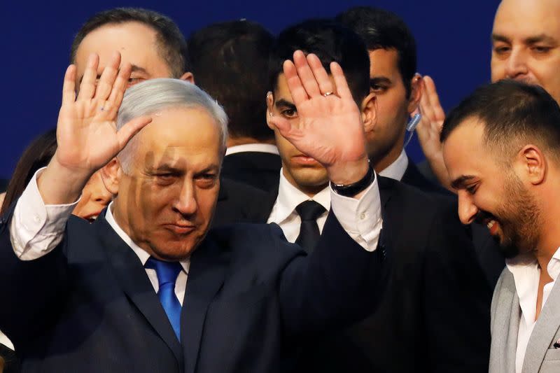 Israeli Prime Minister Benjamin Netanyahu gestures after speaking to supporters following the announcement of exit polls in Israel's election at his Likud party headquarters in Tel Aviv