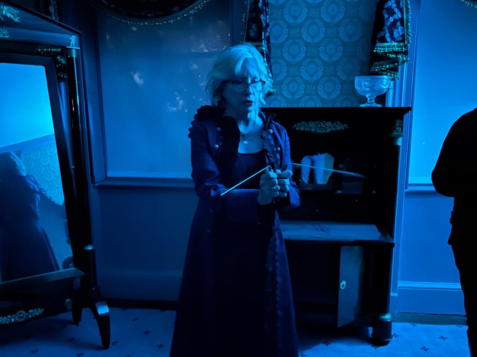 Karen Compton uses dousing rods to detect paranormal activity at the Morris-Jumel Mansion.