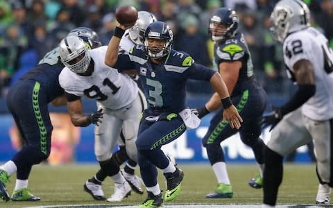 Quarterback Russell Wilson #3 of the Seattle Seahawks rushes against the Oakland Raiders at CenturyLink Field on November 2, 2014 - Credit: (Otto Greule Jr/Getty Images)