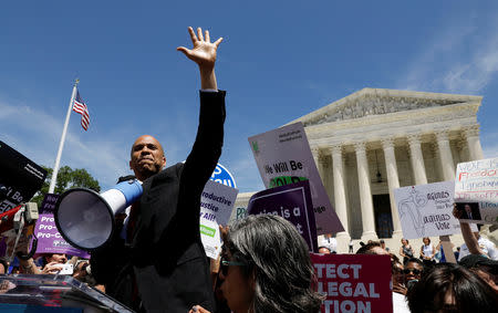 Democratic U.S. presidential candidate Sen. Cory Booker (D-NJ) waves to the crowd of protestors after addressing abortion rights activists during a rally outside the U.S. Supreme Court in Washington, U.S., May 21, 2019. REUTERS/Kevin Lamarque