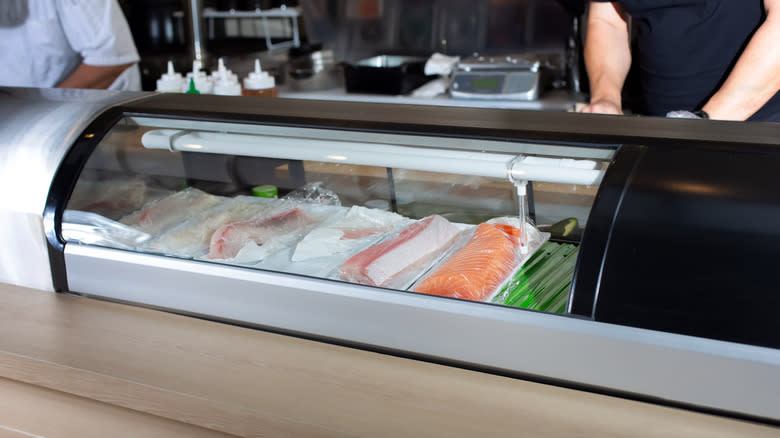 sushi counter with raw fish