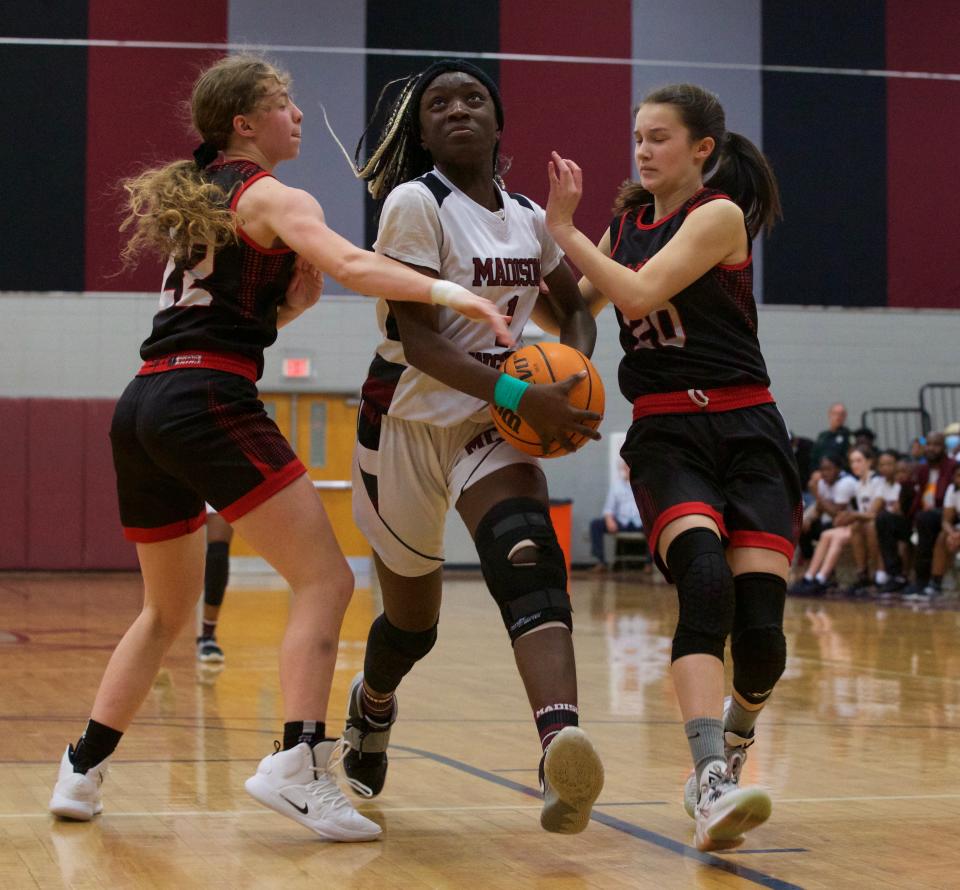 Madison County sophomore Janiyah McKnight (1) battles through two Lafayette defenders in the Class 1A Region 3 championship on Feb. 15, 2022, at Madison County High School. The Cowgirls won, 56-53.