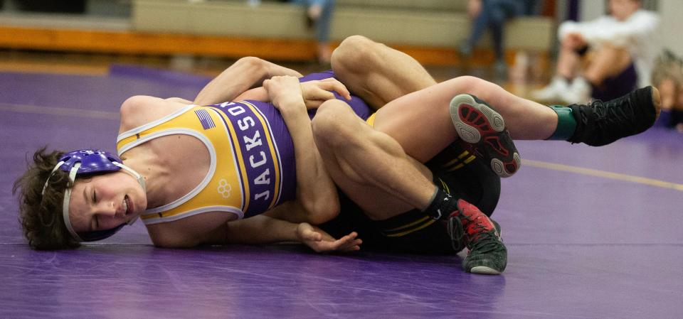Mason Rohr of Perry and Mason Tan of Jackson wrestle in their 120-pound match Wednesday at Jackson.