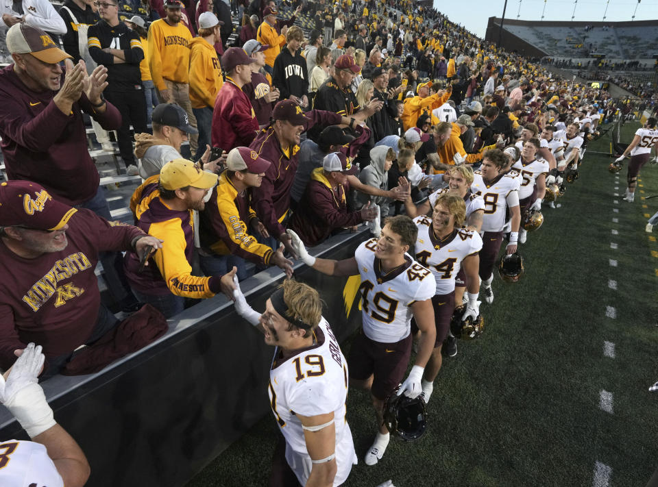 Minnesota celebrates with fans after their 12-10 win over Iowa in a NCAA college football game, Saturday, Oct. 21, 2023, in Iowa City, Iowa. (AP Photo/Matthew Putney)