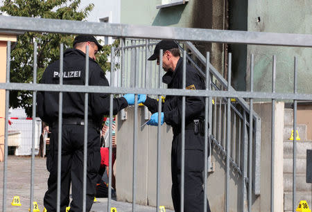 Police inspect the front of a mosque in Dresden, Germany on September 27, 2016, one day after an improvised bomb destroyed the entrance. REUTERS/Matthias Schumann