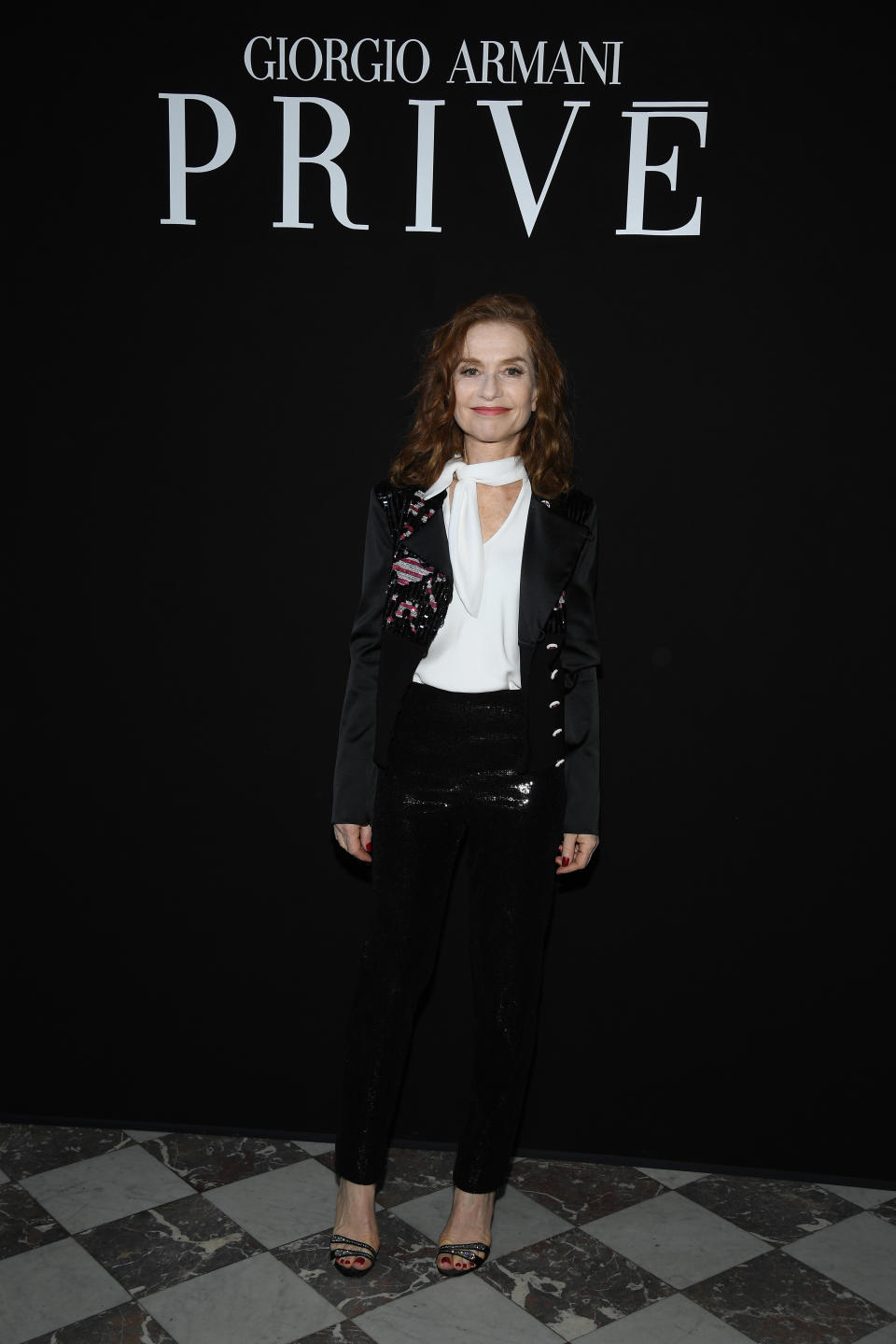 <p>On 3 July, Isabelle Huppert attended the Giorgio Armani Prive show in Paris wearing sequinned trousers and a military-inspired jacket. <em>[Photo: Getty]</em> </p>