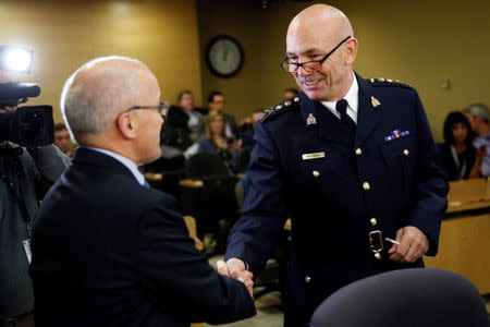 Royal Canadian Mounted Police Commissioner Bob Paulson (R) prepares to testify before a Senate committee in Ottawa October 27, 2014. REUTERS/Blair Gable