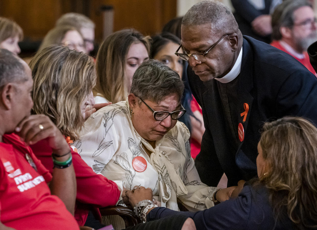 Rev. Sharon Risher, center, whose mother, Ethel Lance was killed in the shooting at the Emanuel AME Church shooting in Charleston, S.C., is comforted during a House Democratic forum urging the Senate to vote on a bill that would expand background checks for gun purchases on Sept. 10, 2019 in Washington, D.C. (J. Scott Applewhite / AP file)