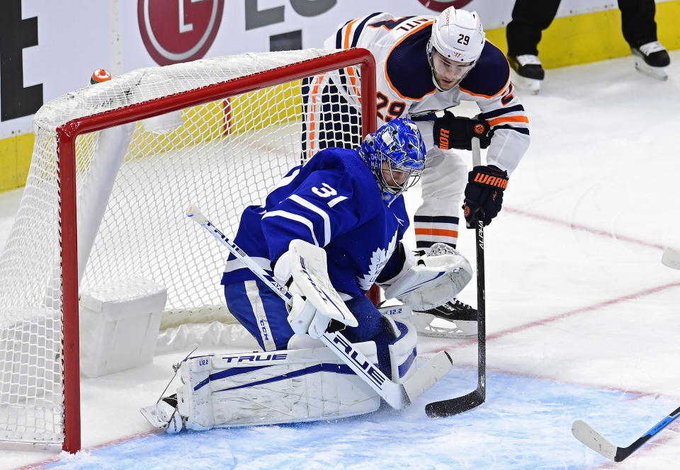 Edmonton Oilers' Leon Draisaitl (29) scores on Toronto Maple Leafs goaltender Frederik Andersen (31) during the second period of an NHL hockey game Friday, Jan. 22, 2021, in Toronto. (Frank Gunn/The Canadian Press via AP)