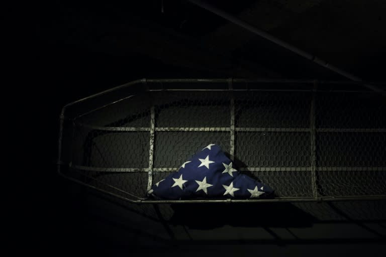 A flag used at the closing ceremony of Ground Zero and a traditional style FDNY "stokes basket" used to carry out the remains of thousands who died on 9/11 is displayed at the 9/11 Tribute Museum in New York on June 12, 2017