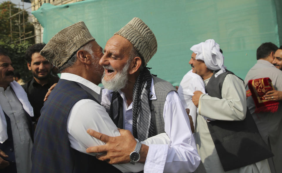 Afghan Muslims greet each other after offering Eid al-Adha prayers in Kabul, Afghanistan, Sunday, Aug. 11, 2019. Muslim people in the country celebrate Eid al-Adha, or the Feast of the Sacrifice by slaughtering sheep, goats and cows whose meat will later be distributed to the poor.(AP Photo/Rafiq Maqbool)