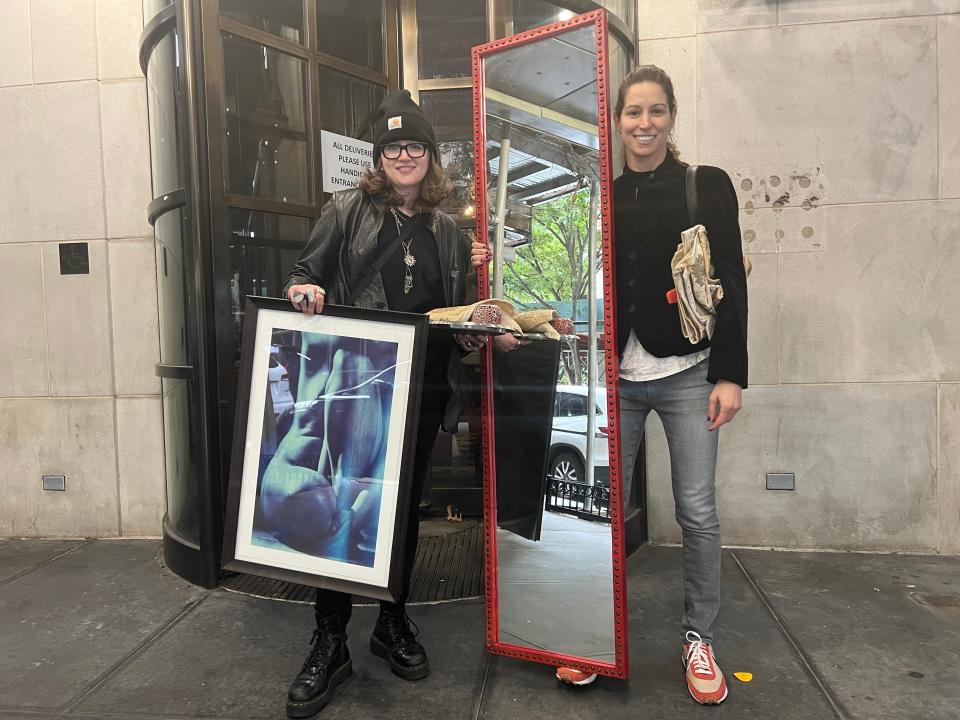 People with furniture they bought at the Gramercy Park Hotel liquidation sale in New York City