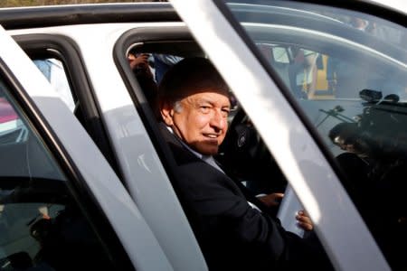 Andres Manuel Lopez Obrador, presidential candidate of the National Regeneration Movement (MORENA), gets into his car after offering a floral tribute to commemorate the 80th anniversary of the expropriation of Mexico's oil industry at Lazaro Cardenas monument in Mexico City, Mexico March 18, 2018. REUTERS/Ginnette Riquelme