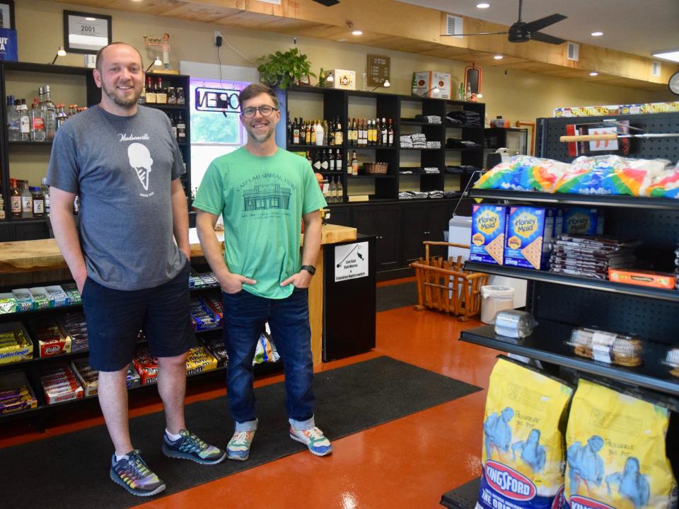 Michael Ashbaugh-Cutler (left) and Jon Ashbaugh-Cutler (right) stand in the newly rebuilt Carp Lake General Store at  6420 E. Gill Road.