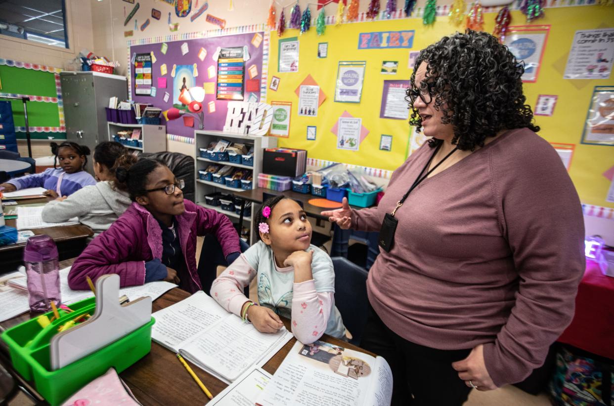 Alyssa Colon-Garcia, executive director of English language arts for K-12 and early childhood education in for the Yonkers Public Schools, works with Savannah Parker and Janeya Miller, fourth graders at the Cross Hill Academy, on a reading assignment Jan. 8, 2023.