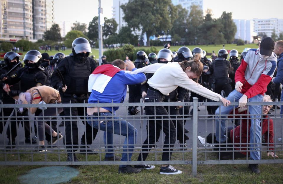 Riot police detain protesters during an opposition rally to protest the presidential inauguration in Minsk, Belarus, Wednesday, Sept. 23, 2020. Belarus President Alexander Lukashenko has been sworn in to his sixth term in office at an inaugural ceremony that was not announced in advance amid weeks of huge protests saying the authoritarian leader's reelection was rigged. Hundreds took to the streets in several cities in the evening to protest the inauguration. (AP Photo/TUT.by)