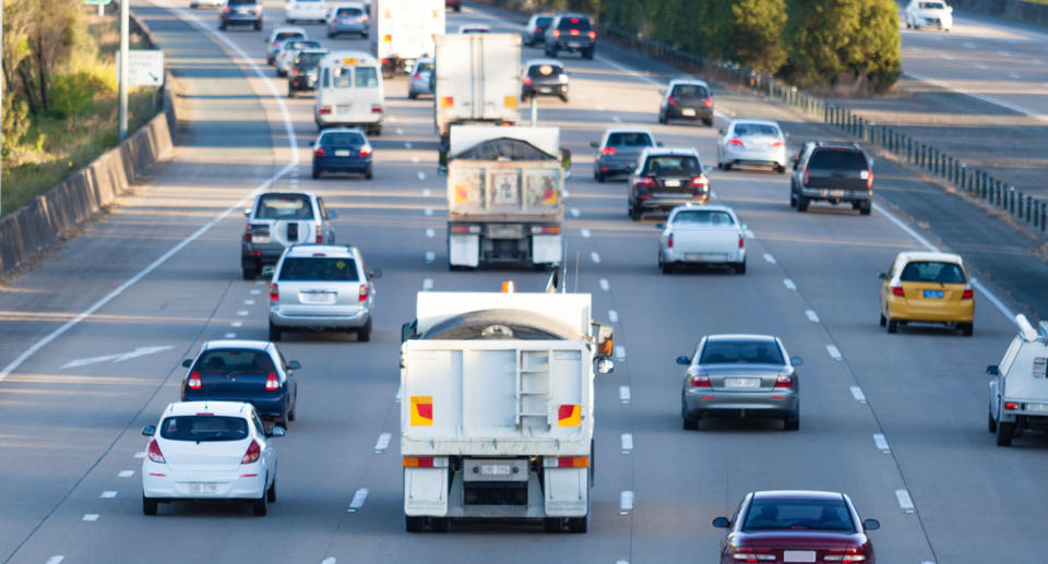 Four lanes of traffic on a busy highway. 