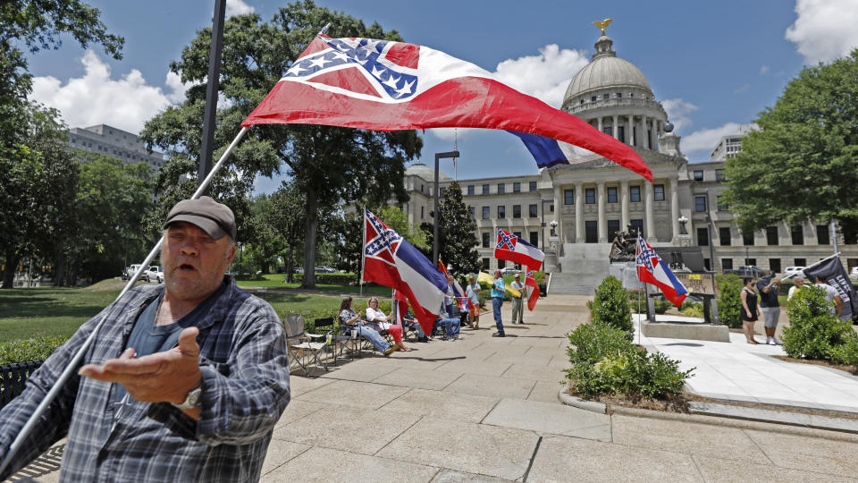 "I love this flag," states David Flynt of Hattiesburg, while standing outside the state Capitol with other current Mississippi flag supporters in Jackson, Miss., Sunday, June 28, 2020. Lawmakers in both chambers are expected to debate state flag change legislation today. Mississippi Governor Tate Reeves has already said he would sign whatever flag bill the Legislature decides on. (AP Photo/Rogelio V. Solis)