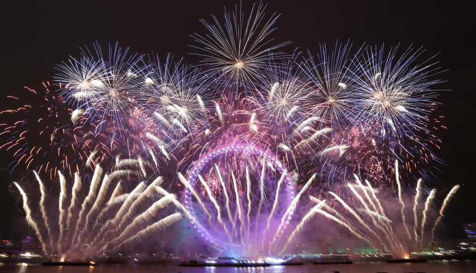 Fireworks explode over the London Eye during the New Year's eve celebrations after midnight in London, Tuesday, Jan. 1, 2019.(AP Photo/Kirsty Wigglesworth)