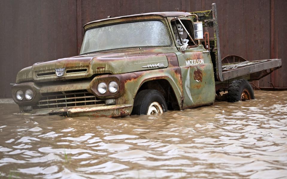 A truck sits in flood waters at the Mickelson Pumpkin Patch in Petaluma, California, on Sunday, February 04, 2024. The US West Coast was getting drenched on February 1 as the first of two powerful storms moved in, part of a "Pineapple Express" weather pattern that was washing out roads and sparking flood warnings. The National Weather Service said "the largest storm of the season" would likely begin on February 4.