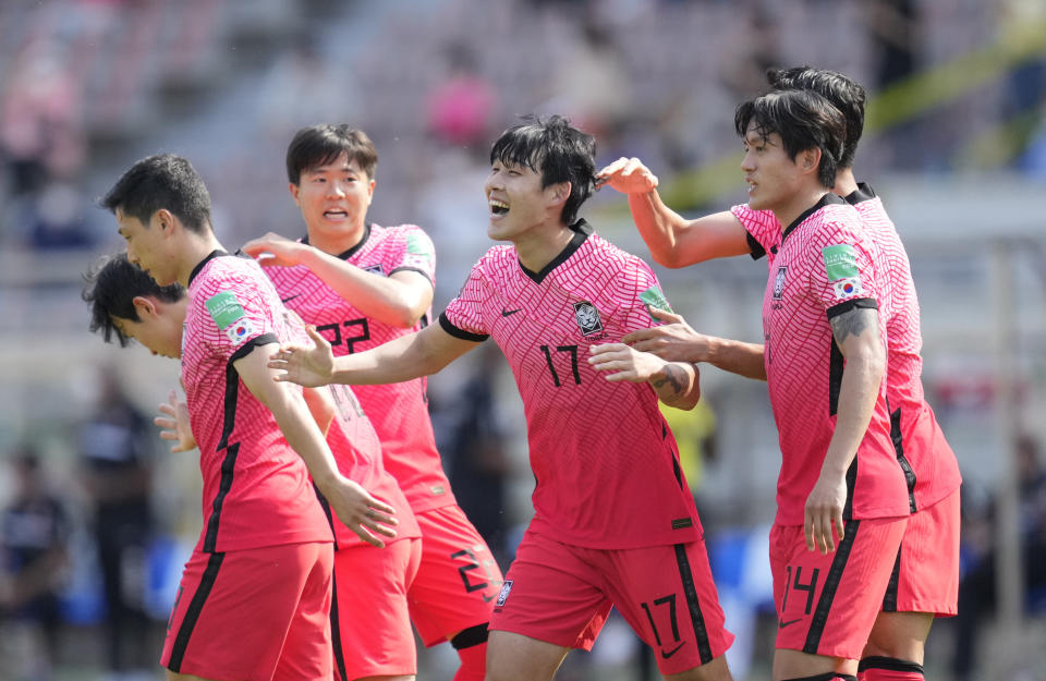 South Korea's Song Min-kyu, center, celebrates after scoring his side's first goal against Lebanon during their Asian zone Group H qualifying soccer match for the FIFA World Cup Qatar 2022 at Goyang stadium in Goyang, South Korea, Sunday, June 13, 2021. (AP Photo/Lee Jin-man)