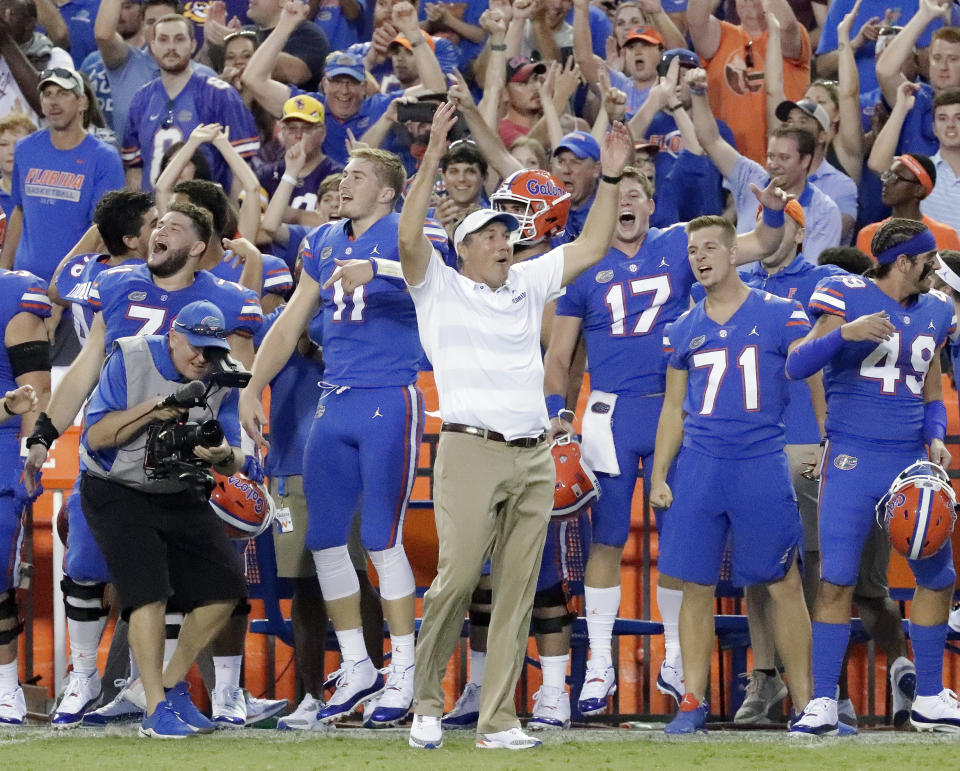 Florida head coach Dan Mullen, center, celebrates with players on the sidelines during the final moments of an NCAA college football game against LSU, Saturday, Oct. 6, 2018, in Gainesville, Fla. (AP Photo/John Raoux)