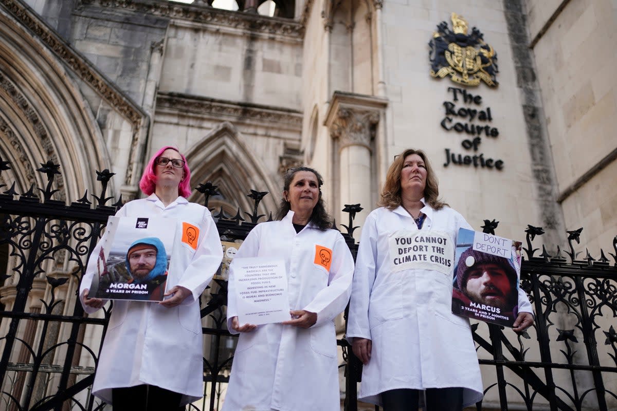 Just Stop Oil protesters outside the Royal Courts of Justice in London, where activists Morgan Trowland and Marcus Decker, are appealing their jail sentences (Jordan Pettitt/PA Wire)