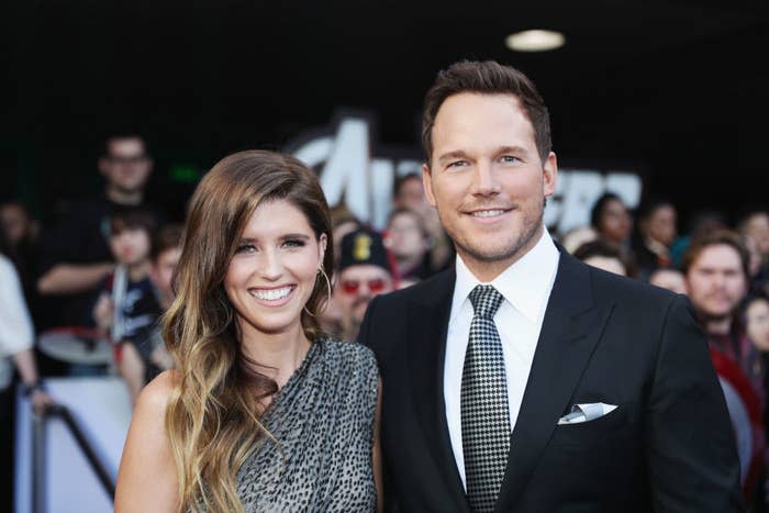 The couple smiling on the red carpet