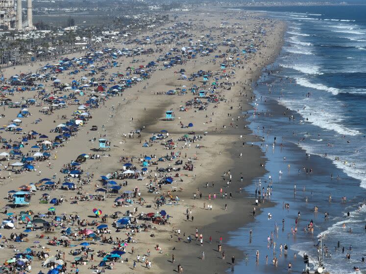 Huntington Beach, CA - July 04: Large crowds celebrate Independence Day after the Huntington Beach parade and before watching fireworks celebration over the ocean at the pier n in Huntington Beach Tuesday, July 4, 2023. (Allen J. Schaben / Los Angeles Times)