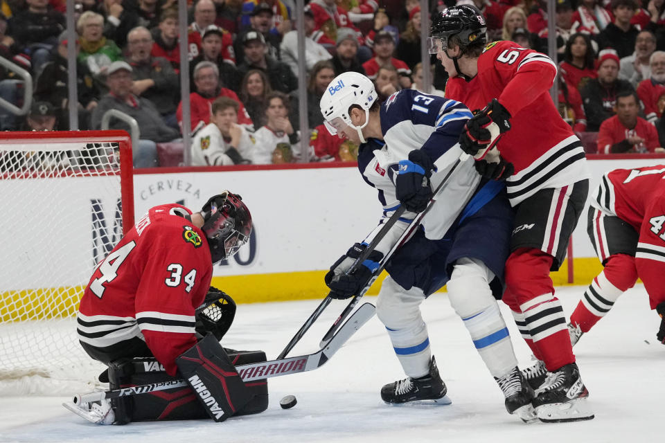 Chicago Blackhawks goaltender Petr Mrazek makes a save against the Winnipeg Jets center Gabriel Vilardi during the second period of an NHL hockey game Wednesday, Dec. 27, 2023, in Chicago. (AP Photo/Erin Hooley)