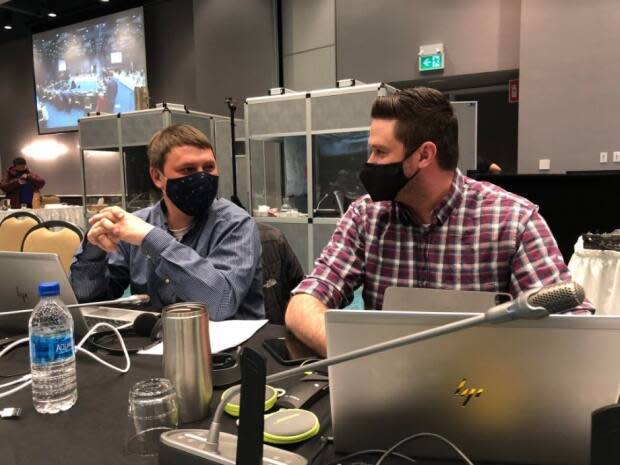 Qikiqtani Inuit Association president P.J. Akeeagok (left) and Jared Ottenhoff, QIA's director of lands and resource management, in discussion at the Nunavut Impact Review Board public hearings on Baffinland's Phase 2 expansion proposal in Iqaluit.