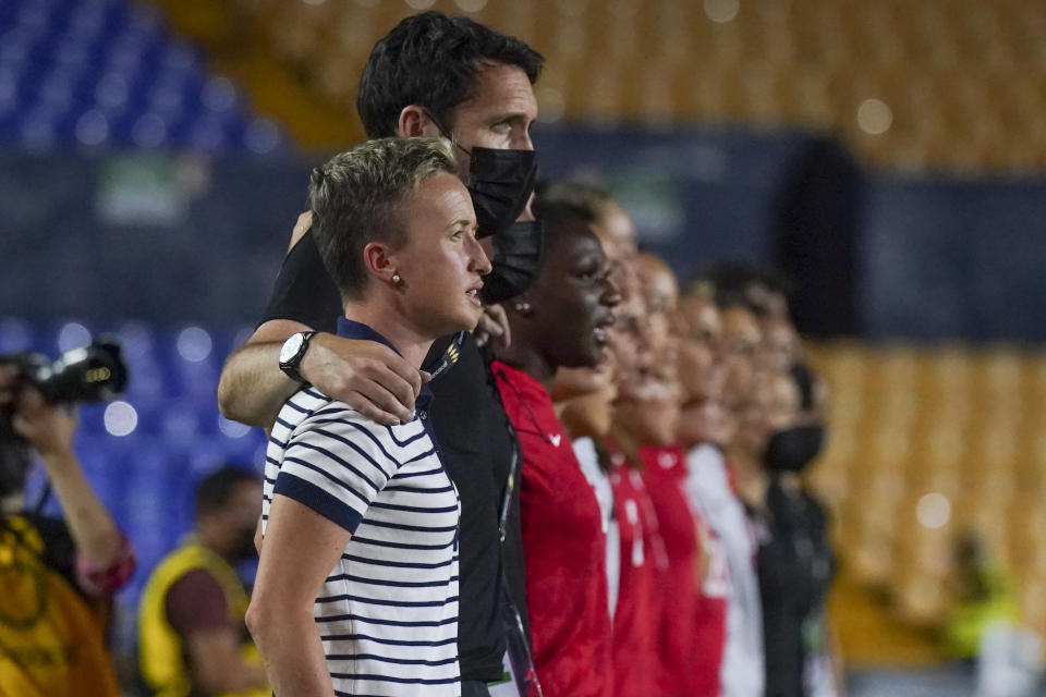 Canada's coach Bev Priestman listens to the national anthem of Canada with her team, prior to a CONCACAF Women's Championship soccer semifinal match against Jamaica in Monterrey, Mexico, Thursday, July 14, 2022. (AP Photo/Fernando Llano)