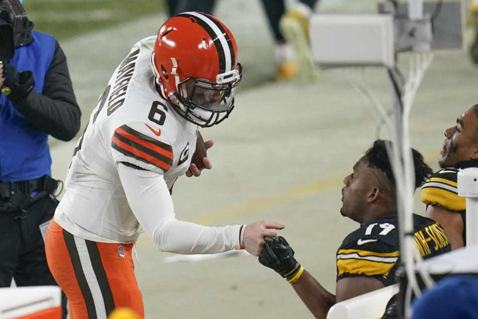 Cleveland Browns quarterback Baker Mayfield (6) greets Pittsburgh Steelers wide receiver JuJu Smith-Schuster (19) after defeating them in an NFL wild-card playoff football game, late Sunday, Jan. 10, 2021, in Pittsburgh. (AP Photo/Keith Srakocic)