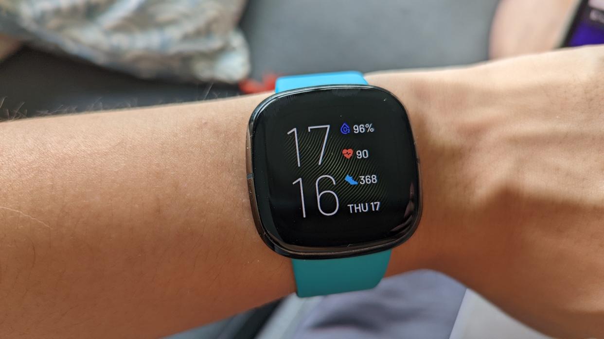 A picture of Fitbit's Sense, a fitness tracker, on a wrist.