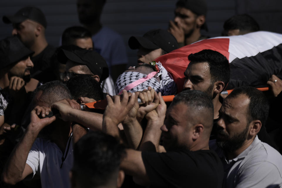 Palestinian mourners carry the body of Tariq Idris, 39, during his funeral, in Askar refugee camp near the West Bank city of Nablus, Saturday, June 24, 2023. Palestinian health officials said that a 39-year-old man, Tariq Idris, died of wounds suffered in violent confrontations with Israeli forces in the northern city of Nablus the day before during an Israeli military arrest raid. (AP Photo/Majdi Mohammed)