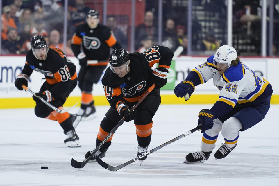 Philadelphia Flyers' Cam Atkinson and Kasperi Kapanen vie for the puck during the second period of an NHL hockey game, Monday, March 4, 2024, in Philadelphia. (AP Photo/Matt Rourke)